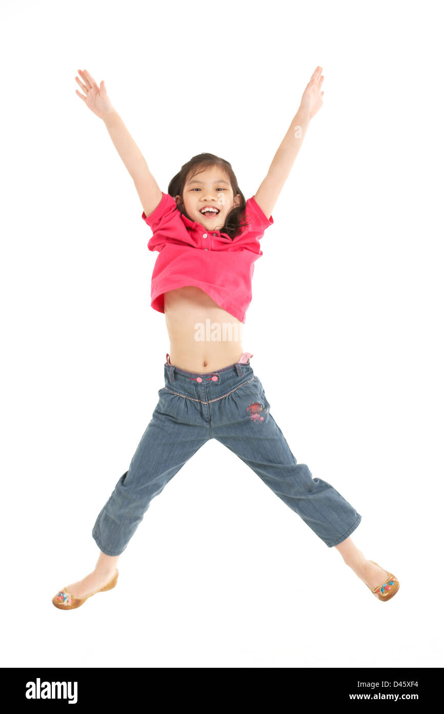 Studio Shot of Chinese Girl Jumping in Air Banque D'Images