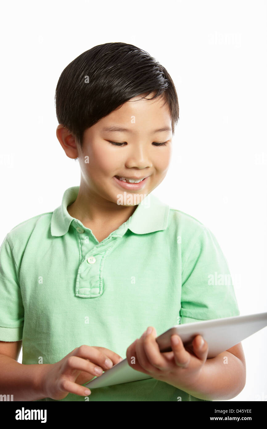 Studio Shot of Chinese Boy With Digital Tablet Banque D'Images