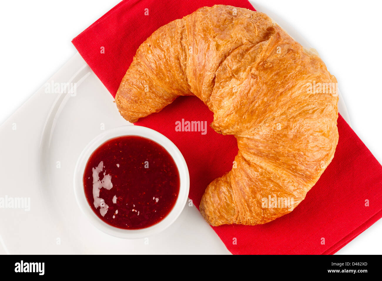 Frissen vágott kalódás gyertyán croissant confiture mit auf teller Banque D'Images