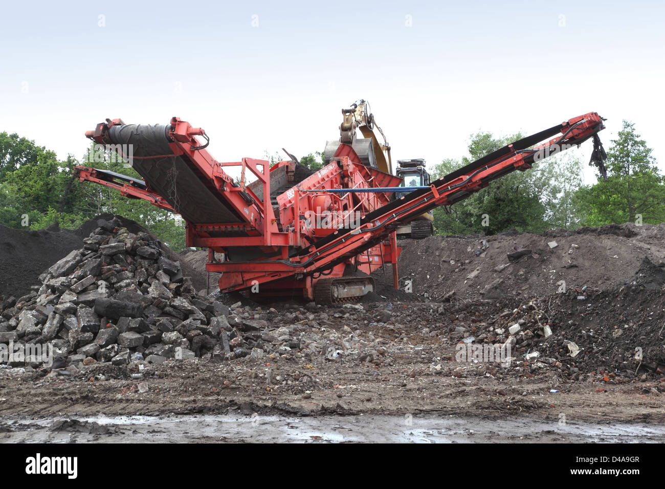 Une machine mobile de concassage et de criblage en opération sur un projet de mise en valeur des terres et de décontamination à Woking, Surrey, UK Banque D'Images
