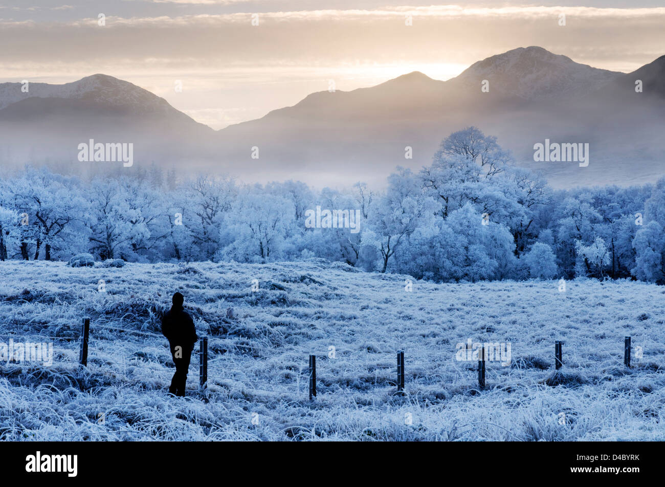 Une personne à admirer la météo glaciale à Glenfinnan dans les Highlands écossais Banque D'Images