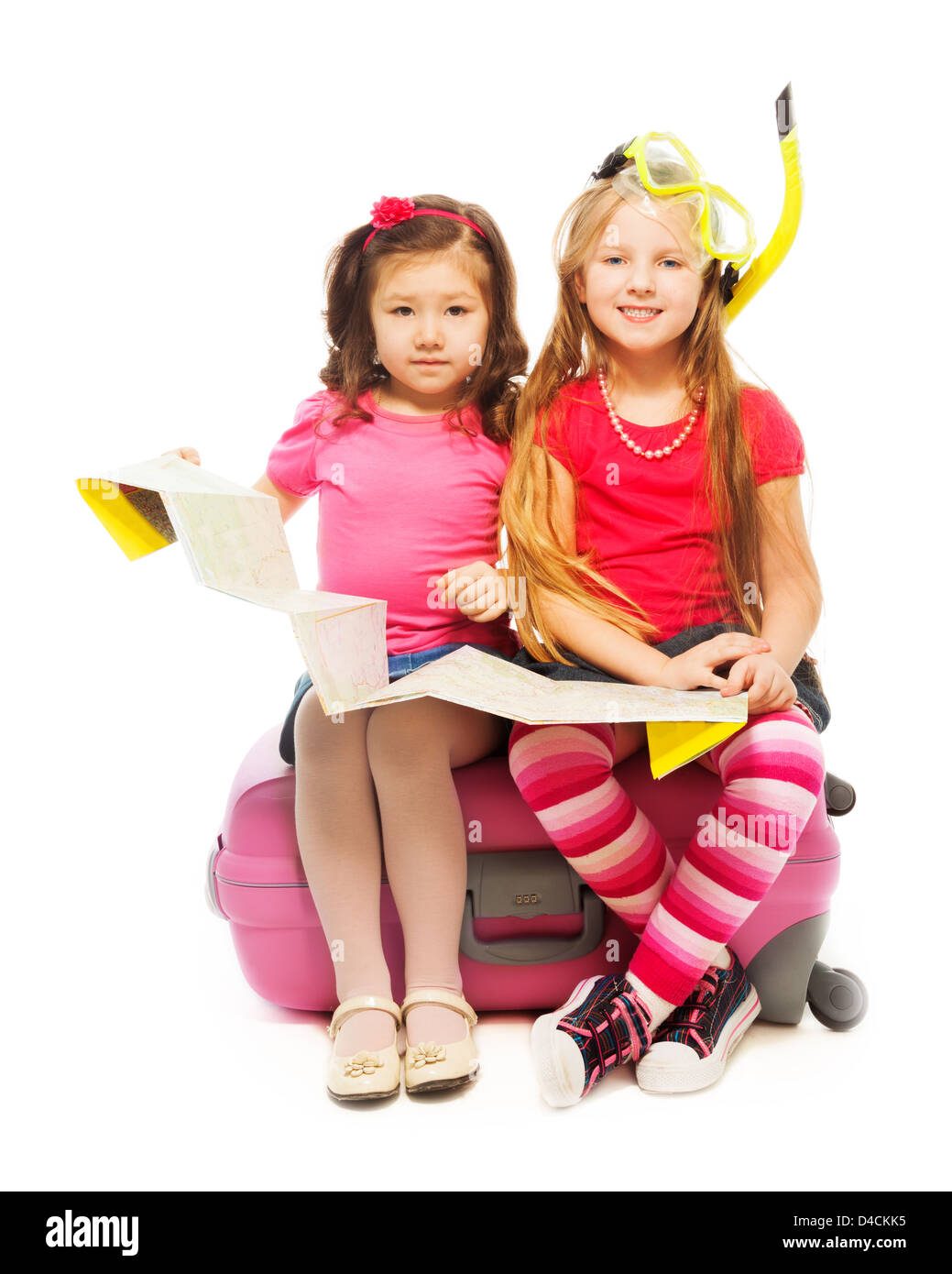 Deux mignonnes petites filles sorti assis sur une valise à la carte préparent un voyage à porter un masque et tuba, isolated on white Banque D'Images