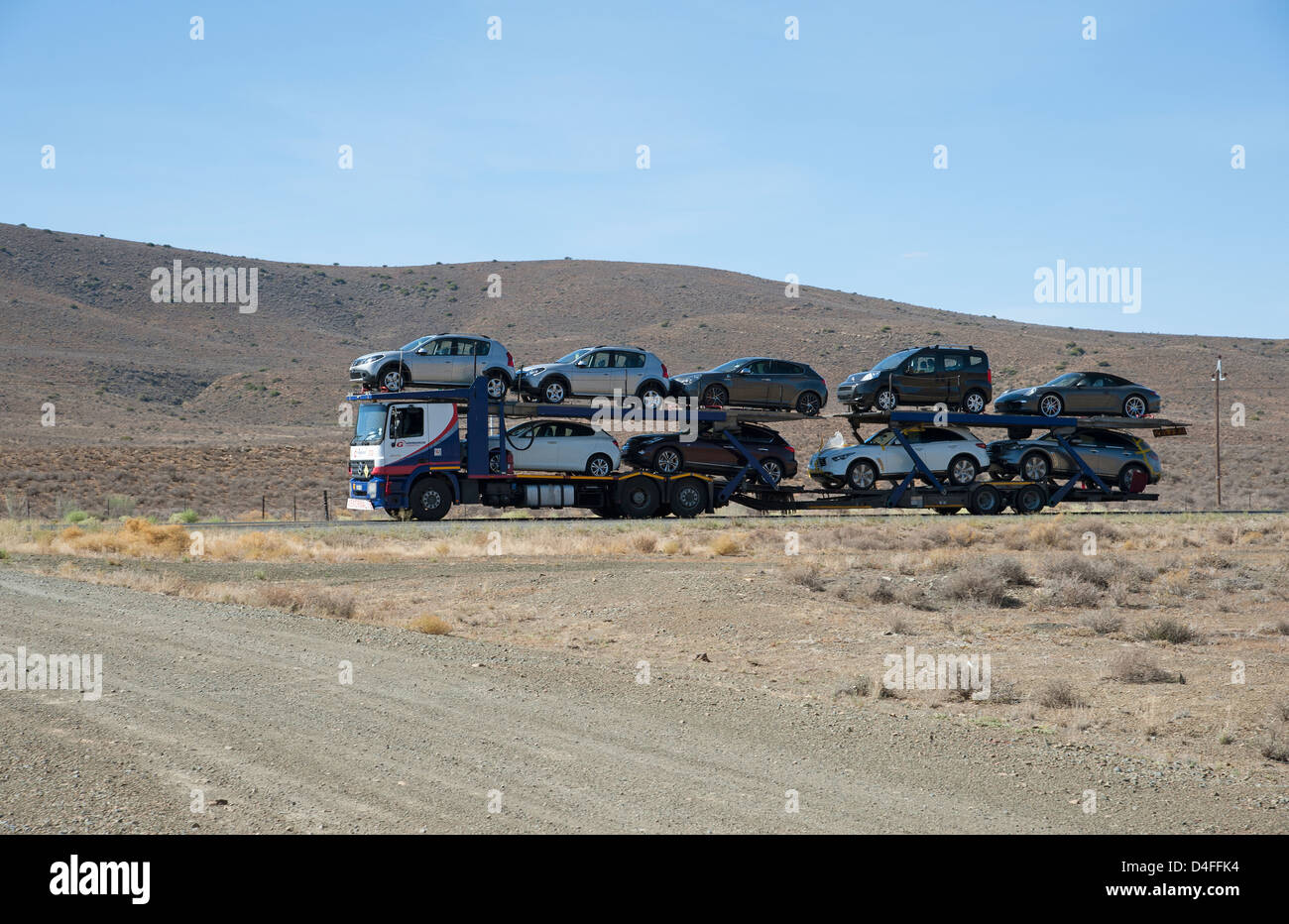 Voiture avec un plein chargement de véhicules circulant sur la N1 à un Lainsburg ville du Karoo, Afrique du Sud Banque D'Images