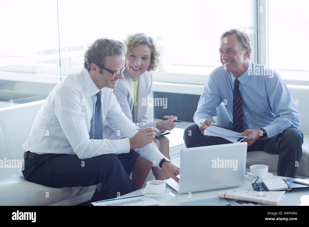 Business people talking in office lobby Banque D'Images