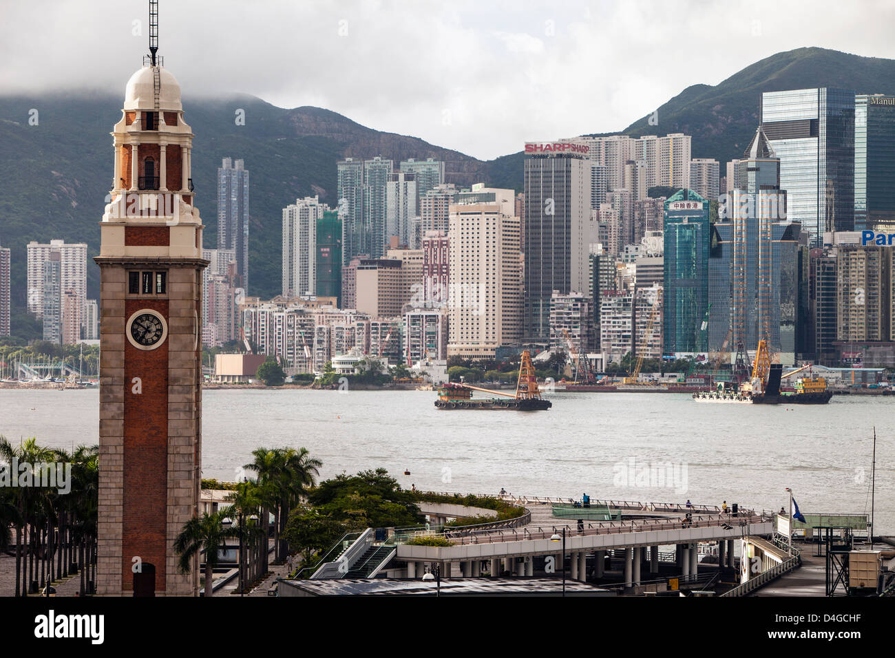 La tour de l'horloge à Kowloon, Hong Kong avec en arrière-plan. Banque D'Images