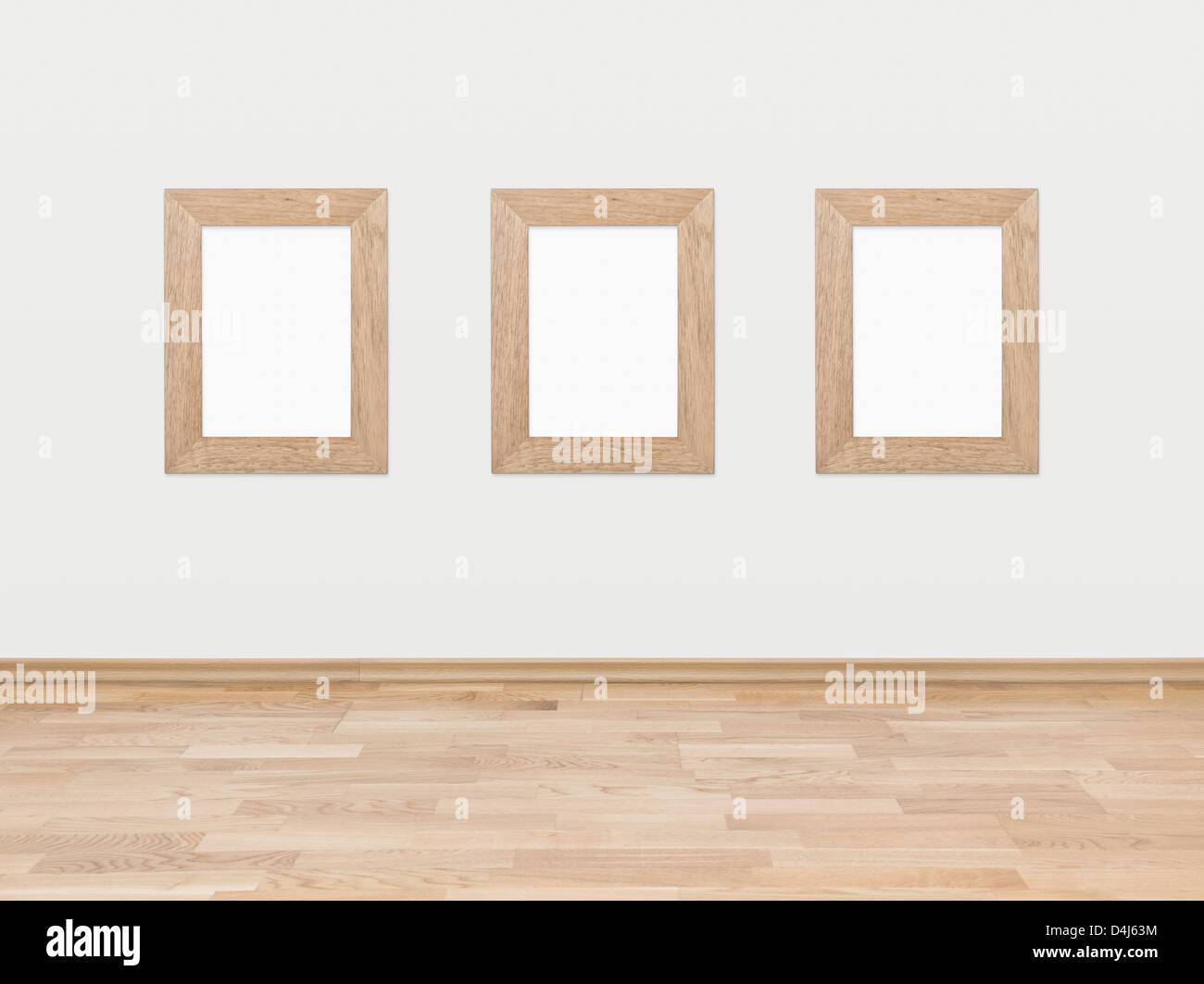 Trois cadres en bois rectangulaire vide affichée sur un mur blanc au-dessus d'un plancher en bois feuillus. Banque D'Images