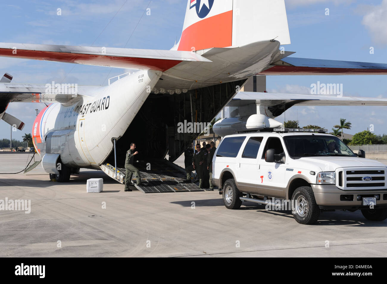 Les camions FEMA sont chargés dans un avion HC-130H Hercules de la Garde côtière américaine pour le transport. La mission souligne le rôle de la Garde côtière dans les opérations de secours en cas de catastrophe, en aidant à la livraison de fournitures essentielles en cas d'urgence. Banque D'Images