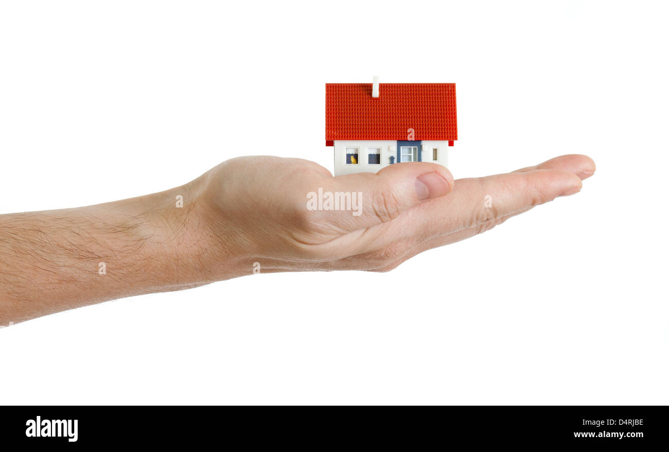Miniature house in hand isolated on white Banque D'Images