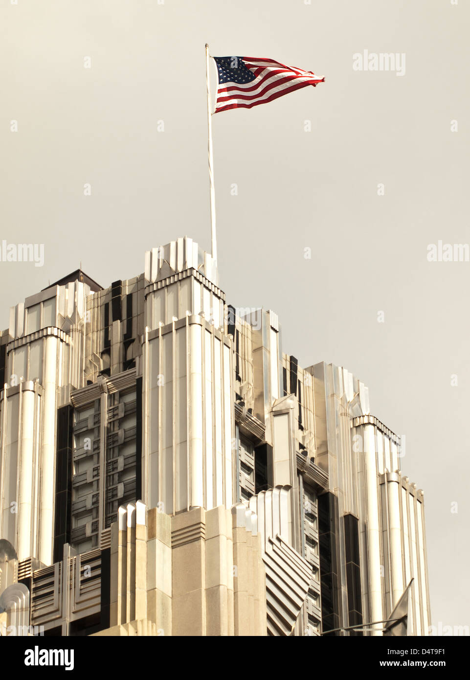 Drapeau américain au sommet d'un gratte-ciel Banque D'Images