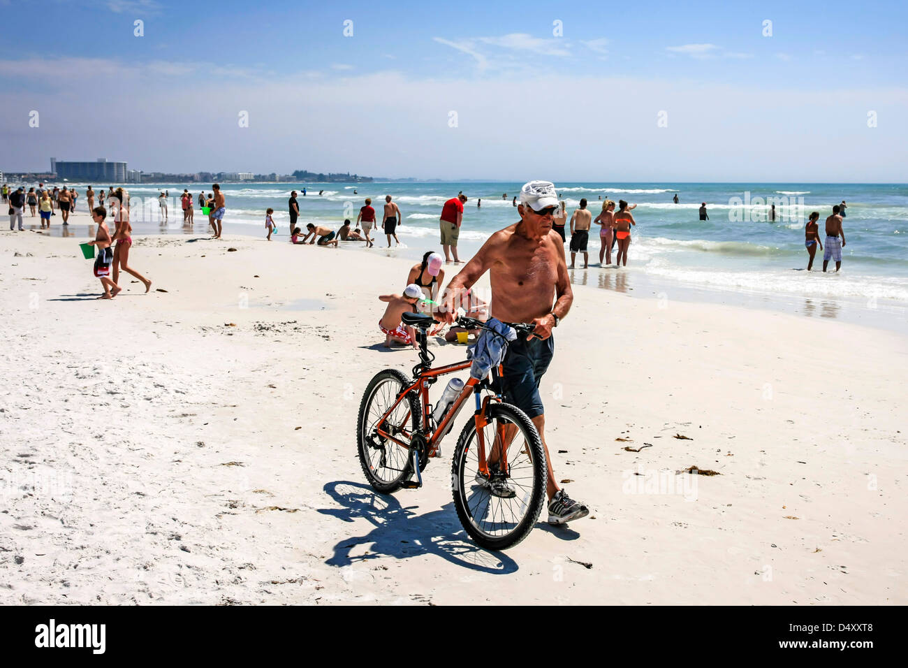 Old man wheeling sa bicyclette sur Siesta Key Beach en Floride pendant les vacances de printemps Banque D'Images