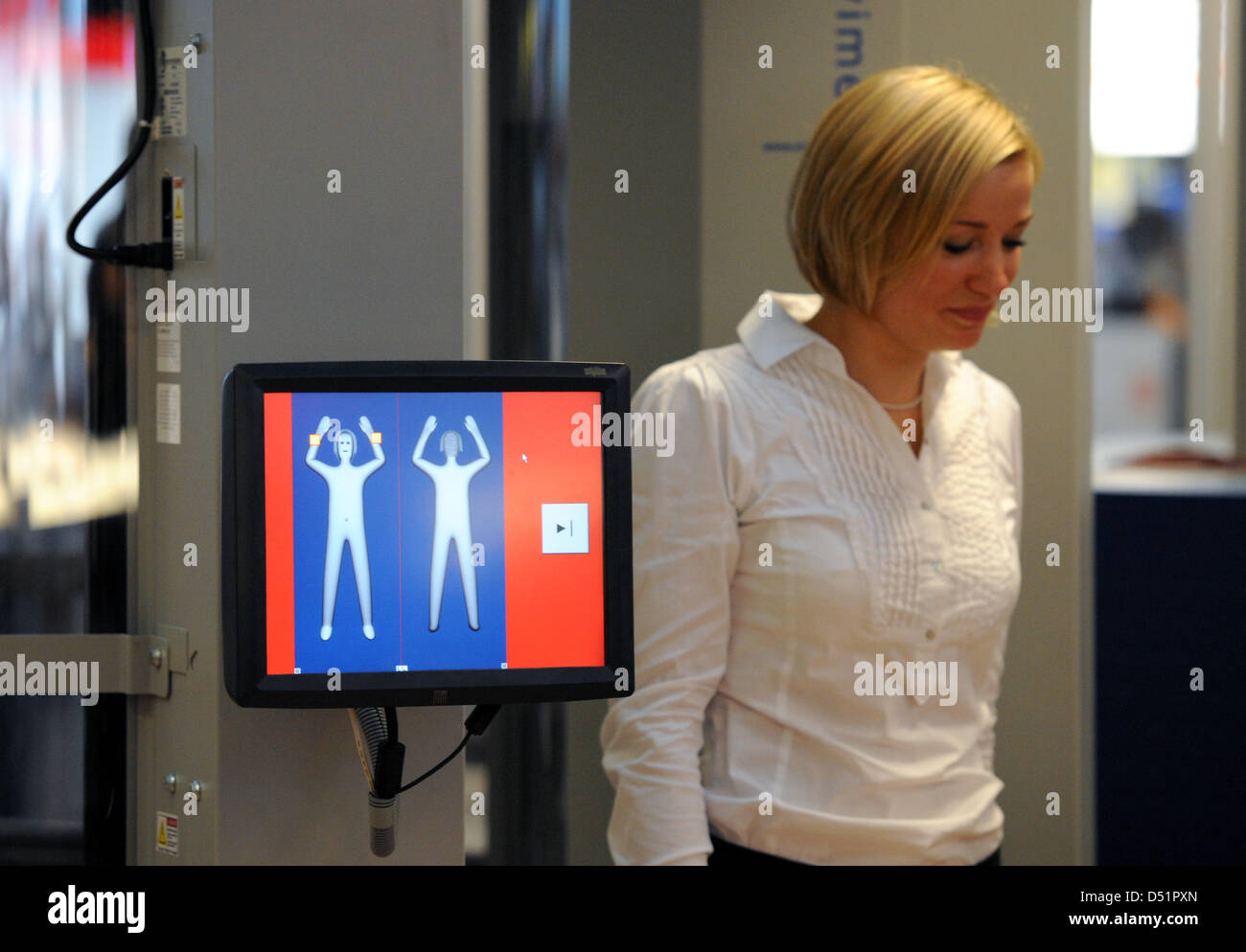 Une femme marche à travers un scanner corporel à l'aéroport de Hambourg,  Allemagne, 27 septembre 2010. Deux de ces appareils seront sur une course  d'essai de deux ans ; leur utilisation est