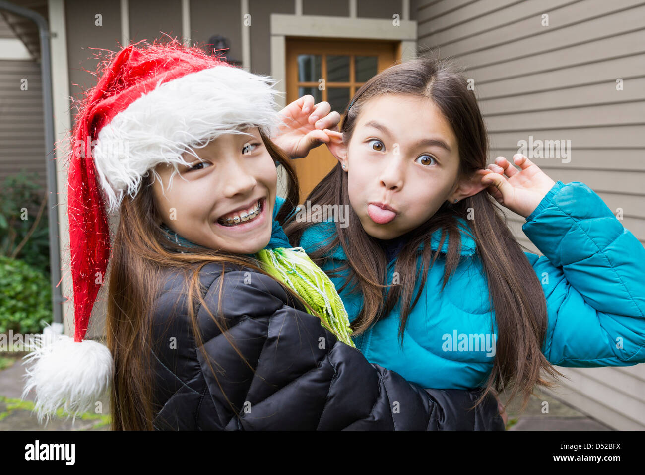 Mixed Race girls making faces Banque D'Images