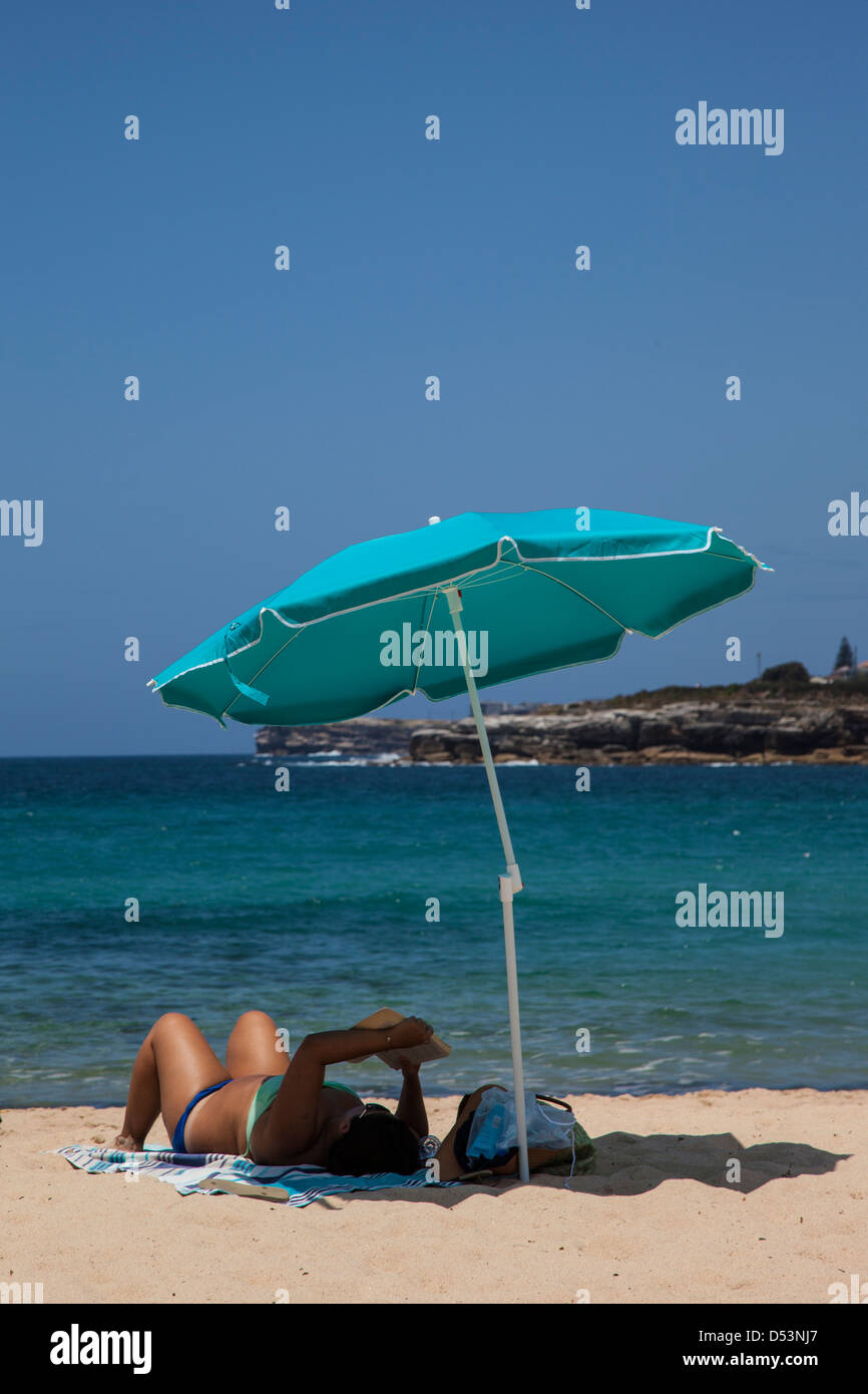 Bronzage femme sur Coogee Beach, Sydney, Australie Banque D'Images