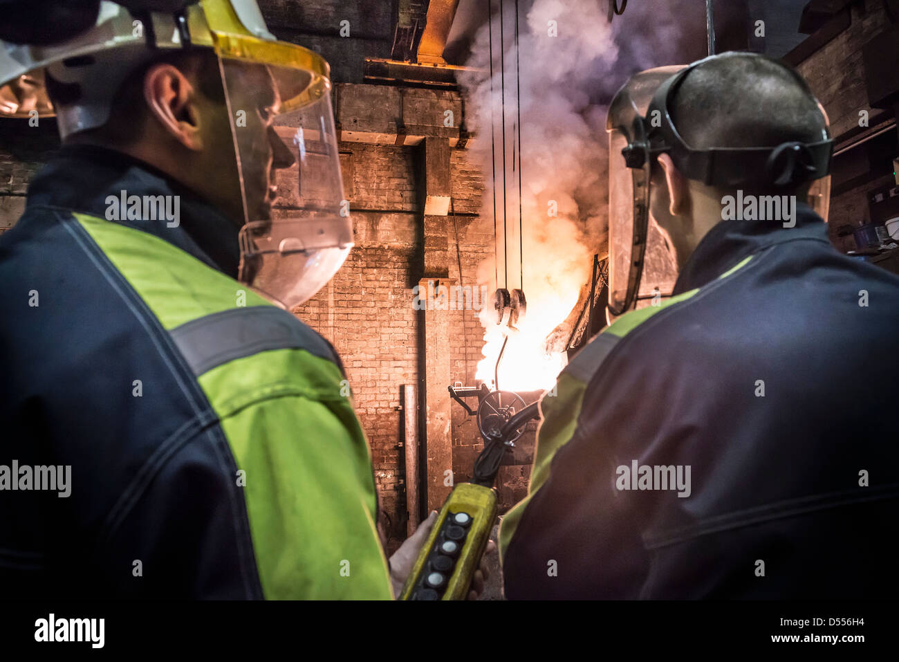 Workers talking in metal foundry Banque D'Images