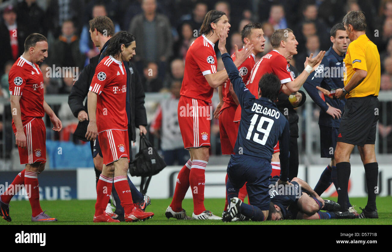Les joueurs du Bayern discuter avec arbitre Roberto Rosetti (R) qui a donné  du Bayern Franck Ribery (L) un carton rouge pour une faute contre Lyon,  Lisandro Lopez (en bas) au cours