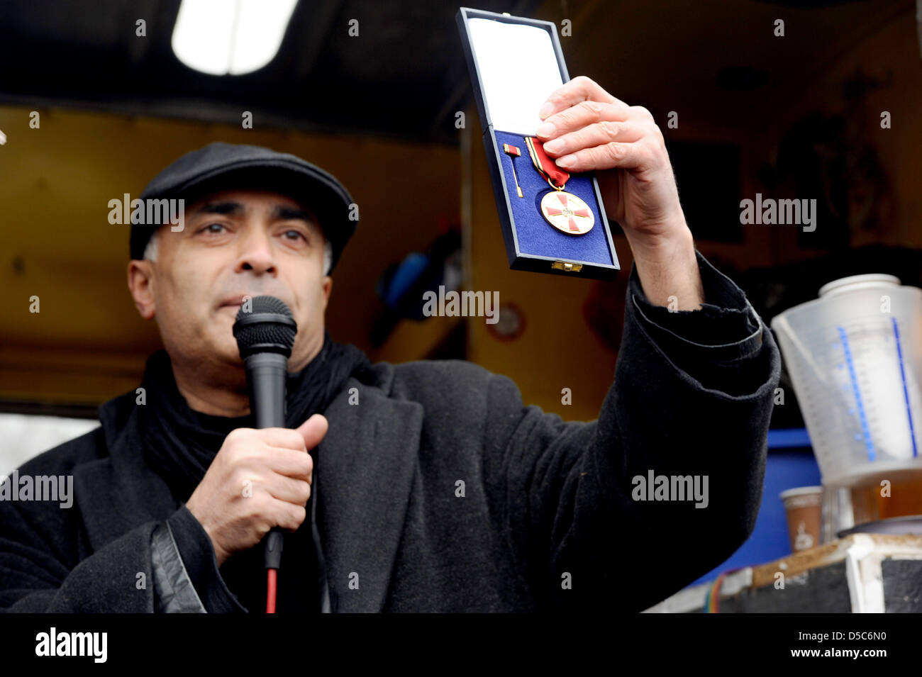 Artiste berlinois Kani Alavi détient sa médaille du mérite de la République fédérale d'Allemagne dans le cadre d'une manifestation devant l'hôtel de ville à Berlin, Allemagne, 28 mars 2013. Le président de l'initiative de l'artiste East Side Gallery veut redonner sa médaille en signe de protestation à la suppression de segments du mur de Berlin et la construction prévue derrière la East Side Gallery. Photo : MARKUS HEINE Banque D'Images