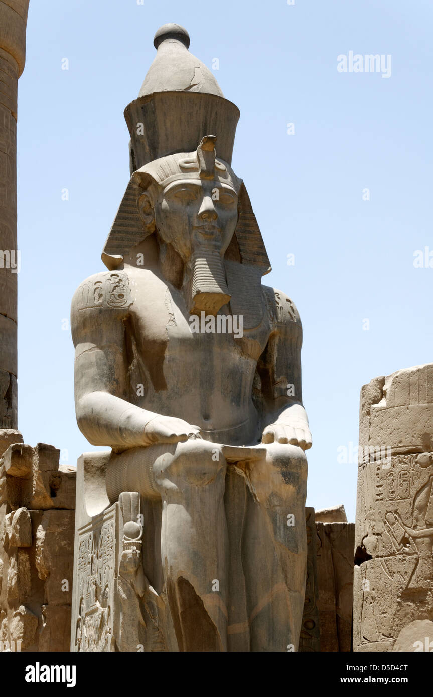 L'Égypte. Une colossale statue de Ramsès flancs l'entrée de la Grande Colonnade d'Amenhotep III au temple de Louxor. Banque D'Images