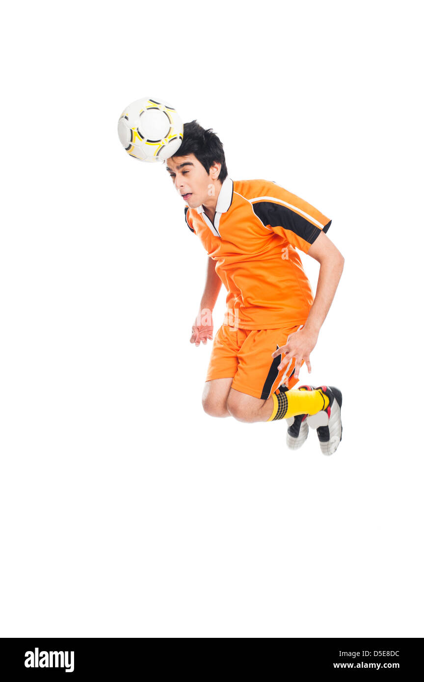 Joueur de football à la tête d'un ballon de soccer Banque D'Images