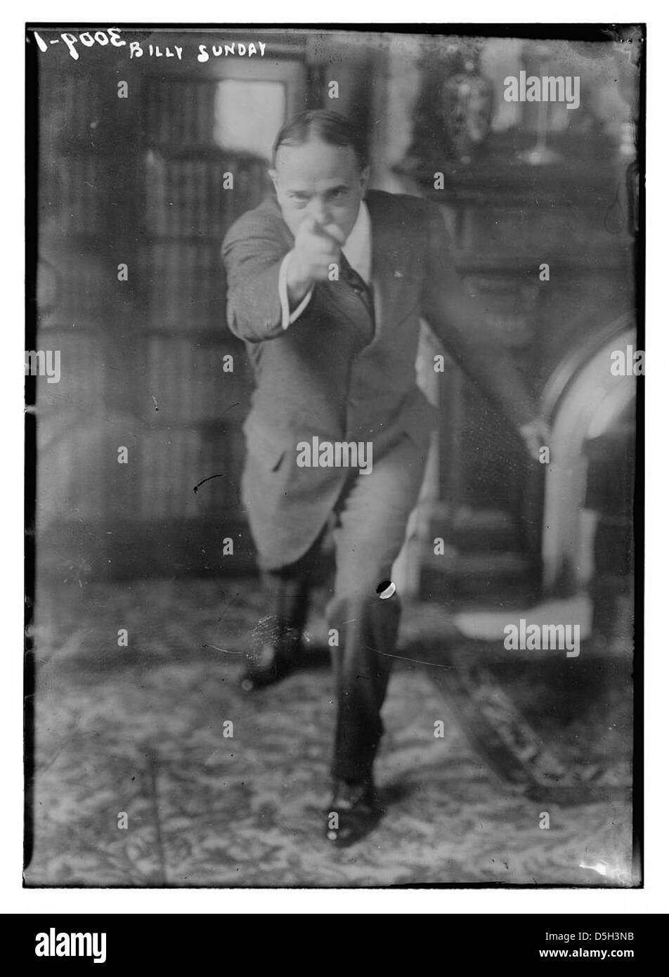 L'évangéliste Billy Sunday est capturé dans ce plan d'action, où il est vu pointer pendant un sermon. Connu pour son style de prédication dynamique, Sunday était une figure importante du christianisme américain du début du XXe siècle. Banque D'Images