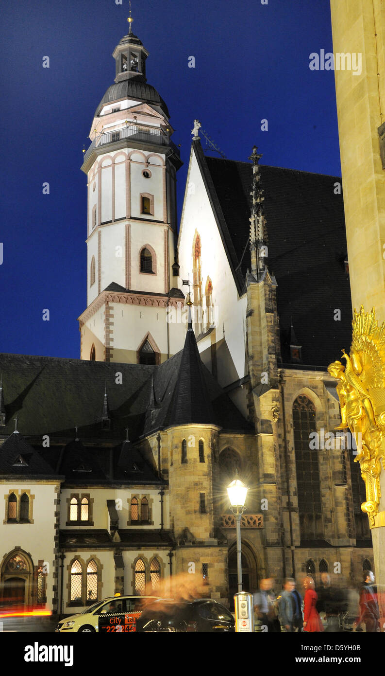 L'église Saint-Thomas de Leipzig est visible dans le contexte d'un bleu clair ciel du soir et à côté d'une statue en or de la Commerzbank à Leipzig, Allemagne, 20 octobre 2012. L'église, siège de la célèbre Thomaner Boy's Choir et dernière demeure de Johann Sebastian Bach, célèbre son 800 anniversaire dans les prochains jours : du 31 octobre 2012, l'église paroissiale cele Banque D'Images