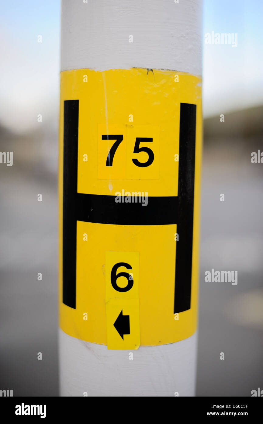 H jaune d'incendie Emplacement sur un lampadaire montrant diamètre de conduite principale d'eau et pas de signe, Pays de Galles, Royaume-Uni. Banque D'Images