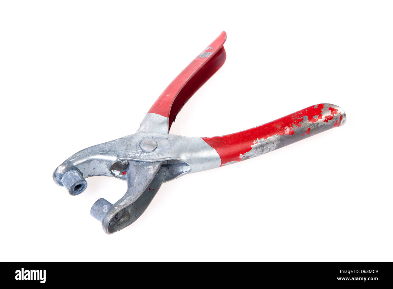 Un outil de rivetage, bien utilisé, avec une poignée rouge dont la peinture écaille. Banque D'Images