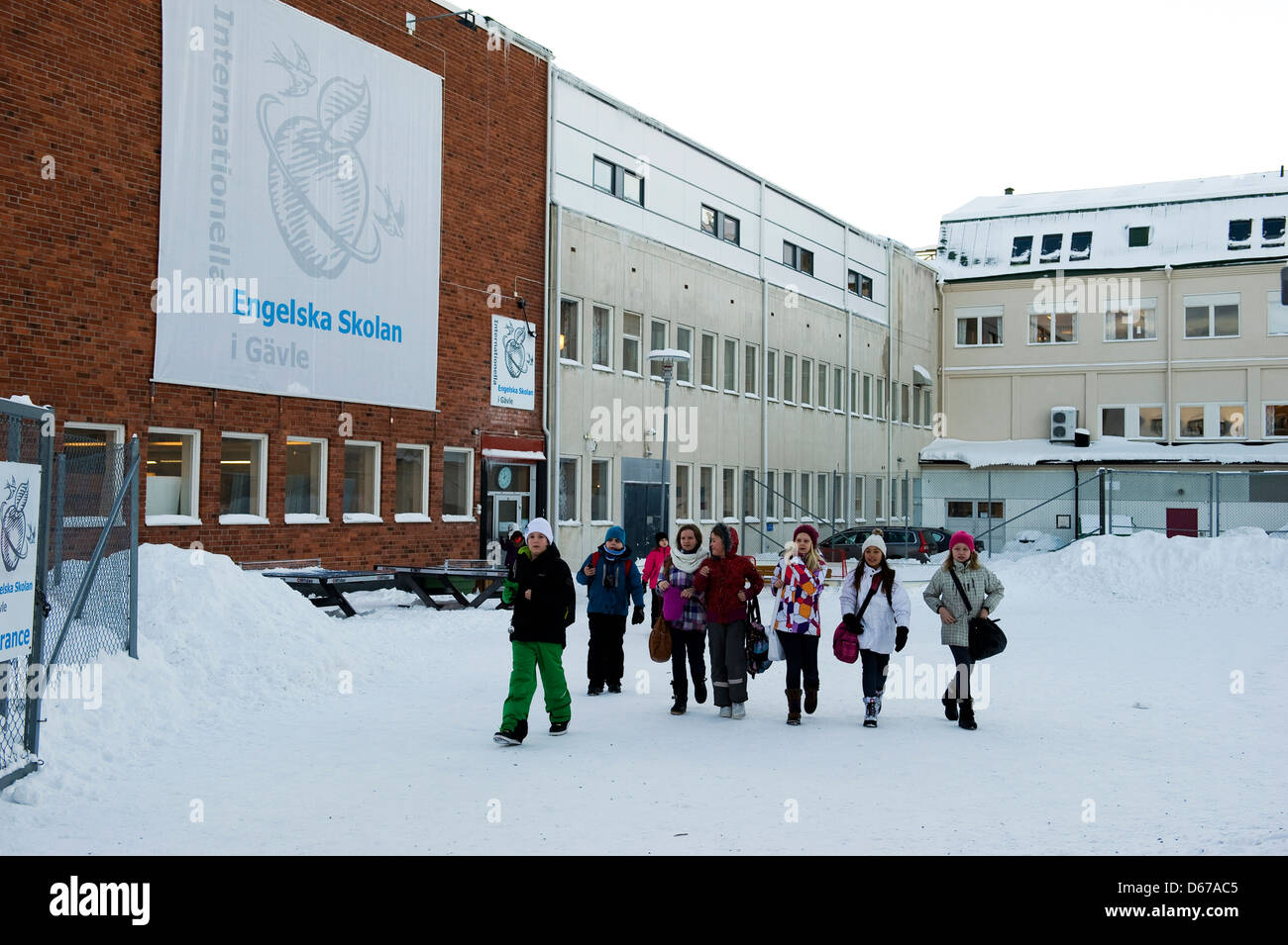 Les enfants de l'école à la sortie de leur école en Suède dans la neige. C'est l'Internationella Franska Skolan, Gavle, Suède. Banque D'Images