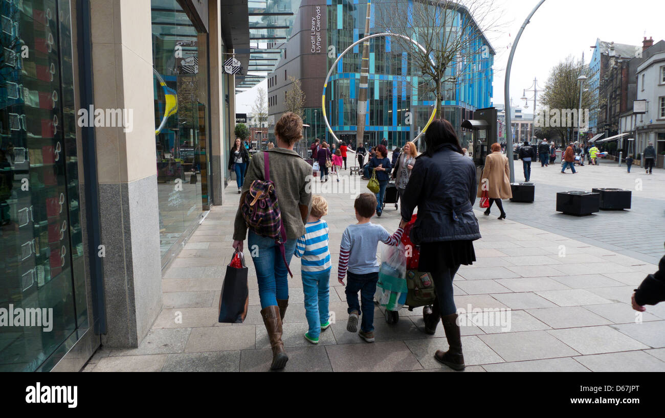 Les gens qui marchent avec des enfants consommateurs dans le centre commercial près de la bibliothèque de Cardiff Cardiff magasin John Lewis et KATHY DEWITT Banque D'Images