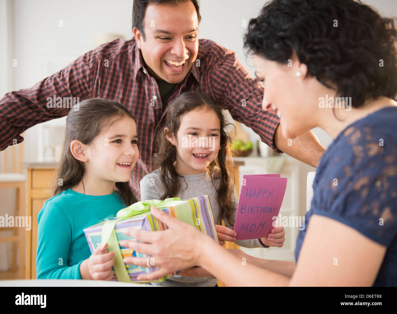 Smiling family celebrating girl's birthday Banque D'Images