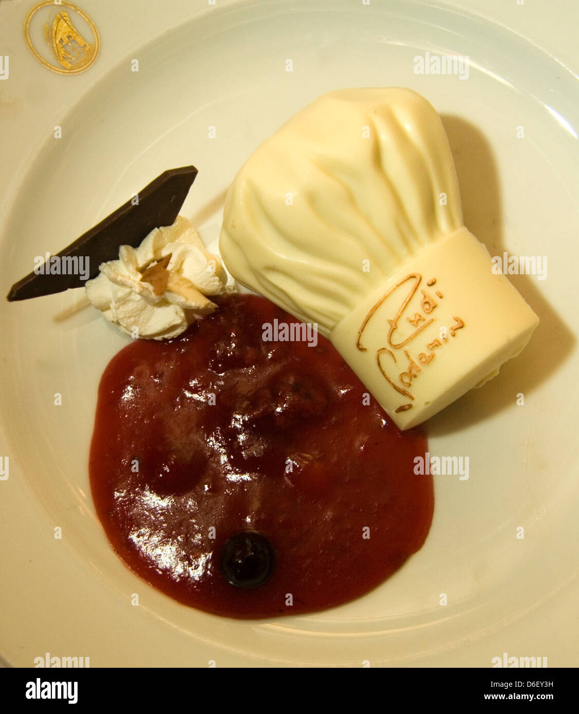 Le chocolat blanc chapeau de chef et d'un coulis de fruits sur le buffet de desserts d'un navire de croisière Banque D'Images