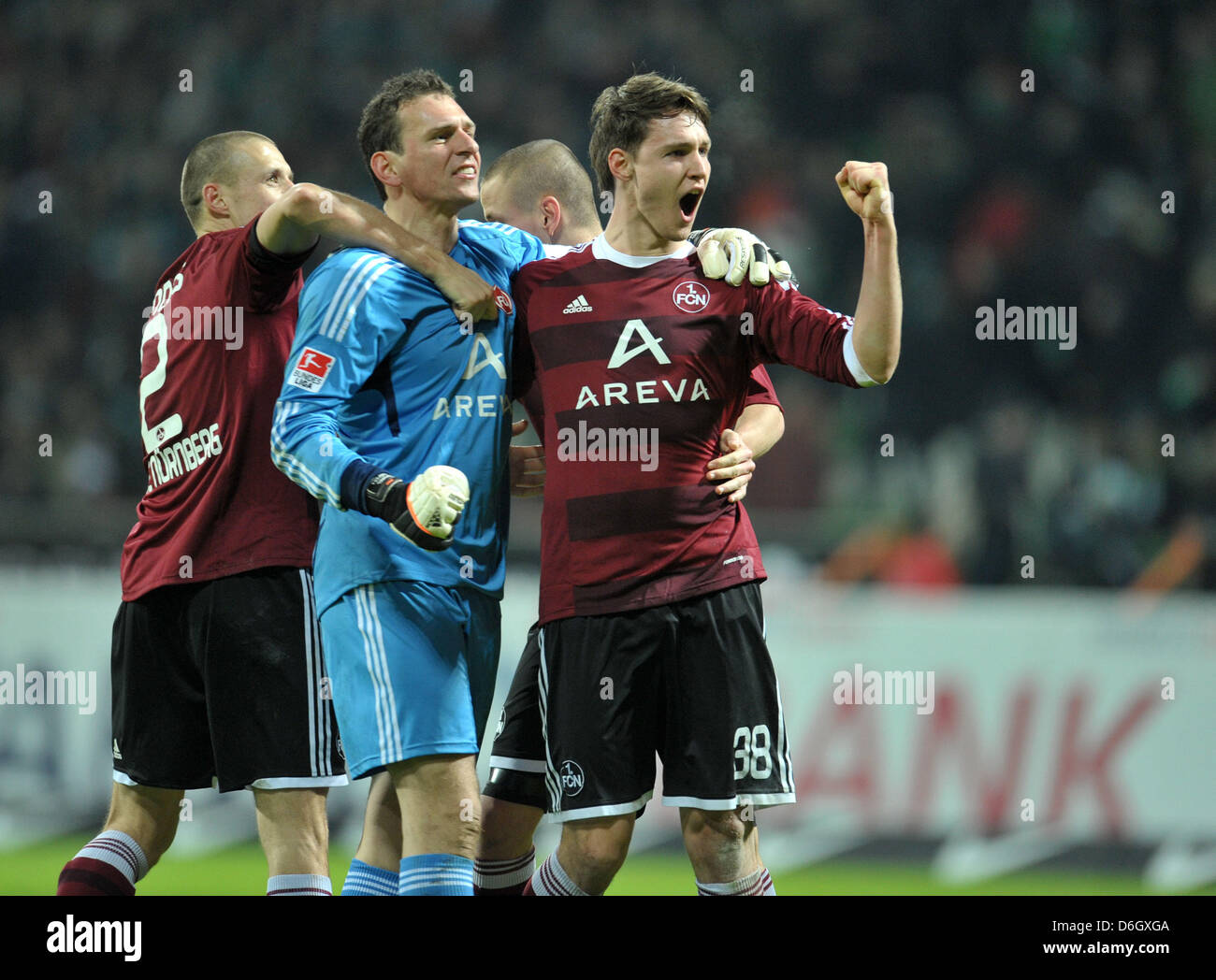 Le gardien Raphael Schaefer (2-L) cheers avec Timmy Simons (L) et Philipp Wollscheid (R) après avoir gagné la Bundesliga match de football entre le Werder Brême et 1. FC Nuremberg au stade Weser à Brême, Allemagne, le 25 février 2012. Photo : Carmen Jaspersen Banque D'Images