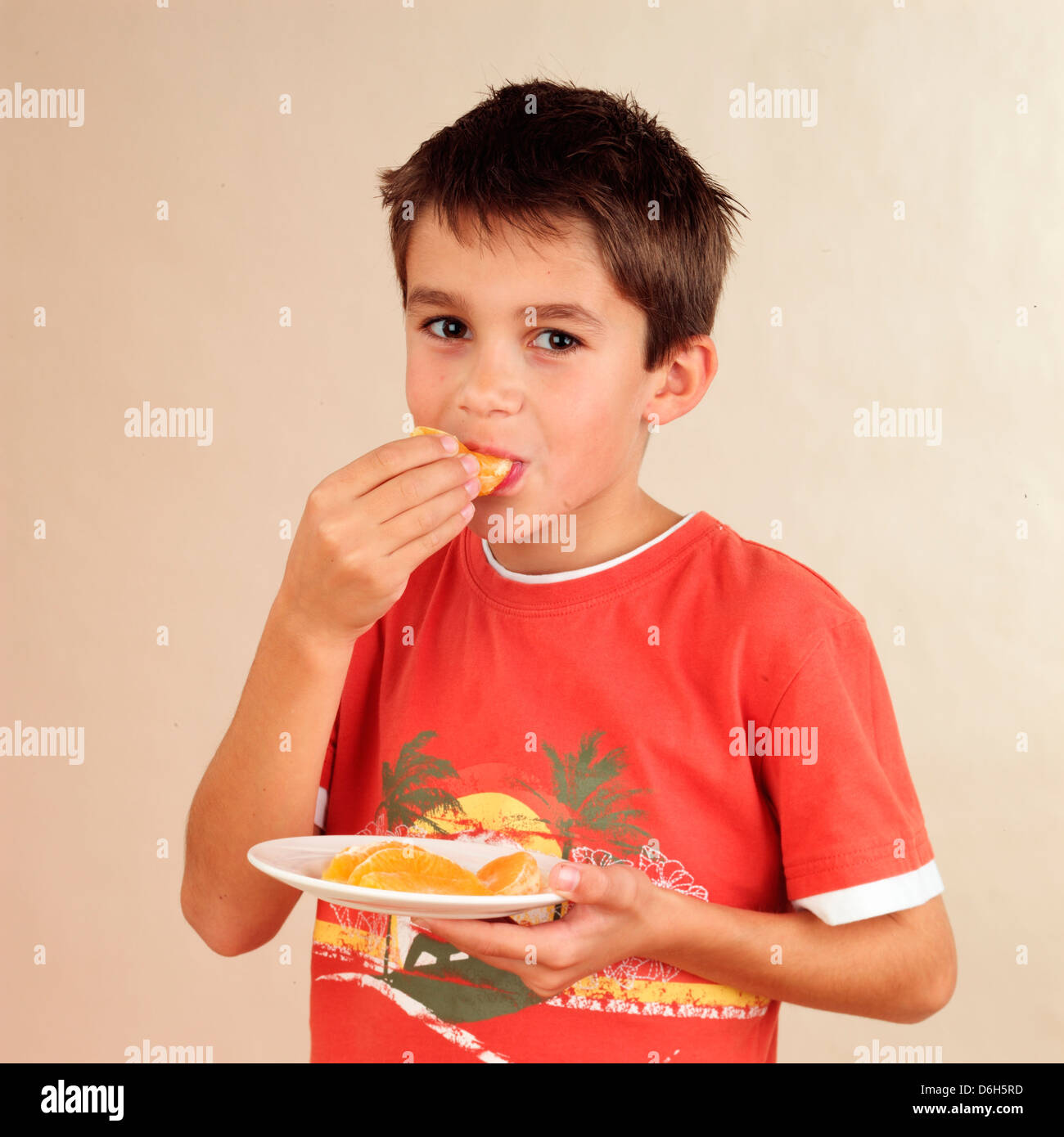 Garçon mange une orange Banque de photographies et d’images à haute résolution Alamy