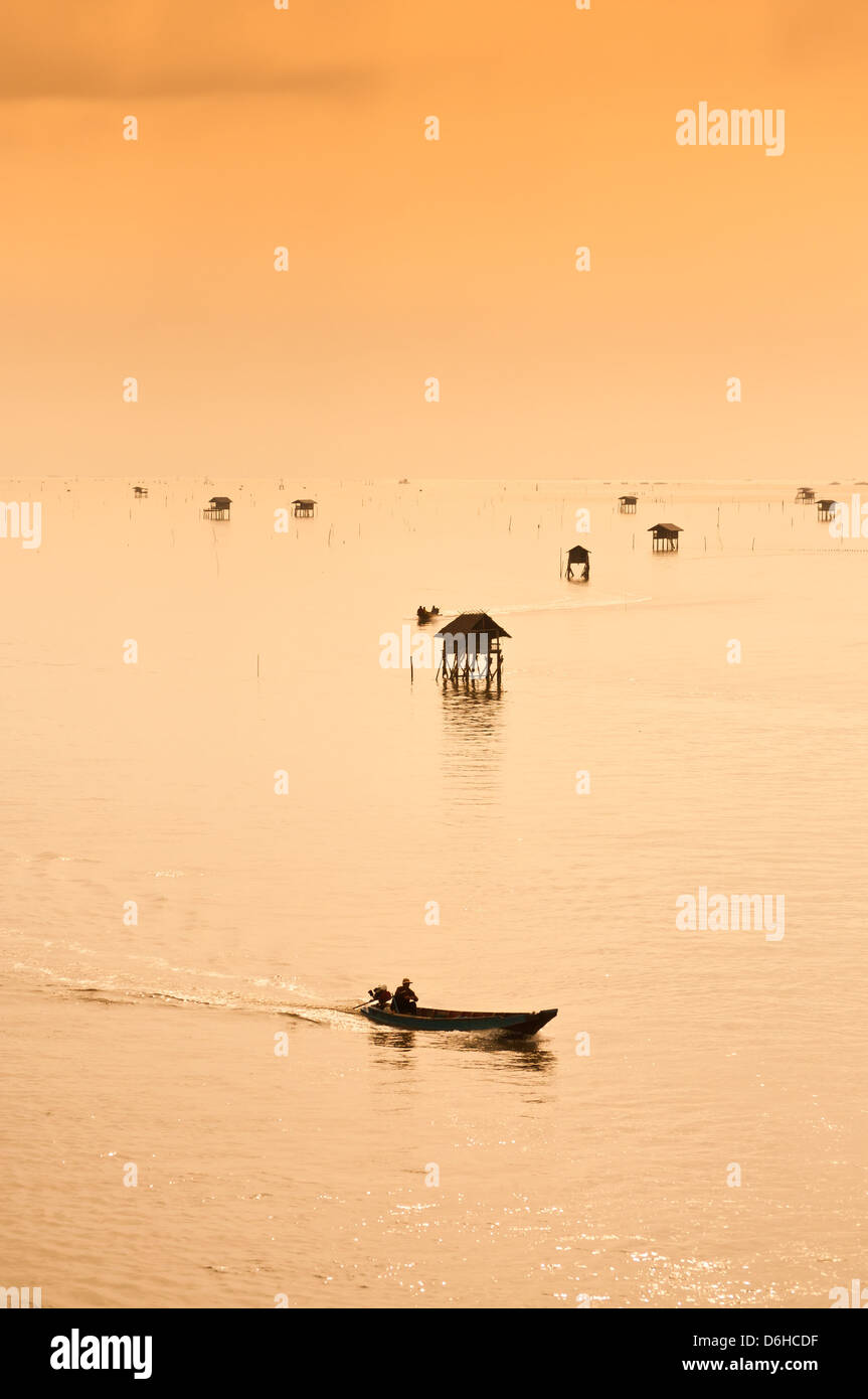 Groupe de cabanes de pêcheurs dans la mer à l'aube. Banque D'Images