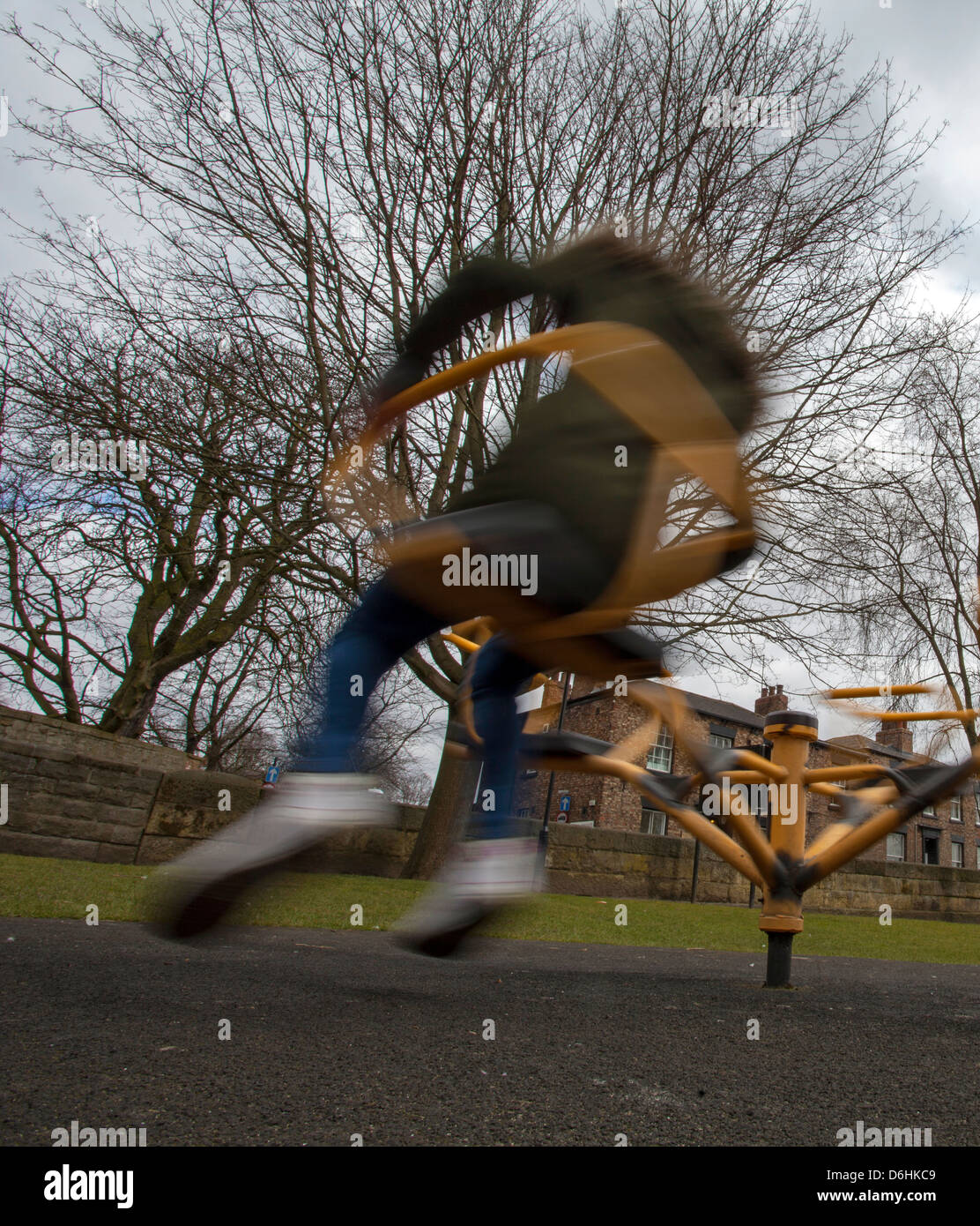 Enfant jouant sur une aire de roundabaout Banque D'Images