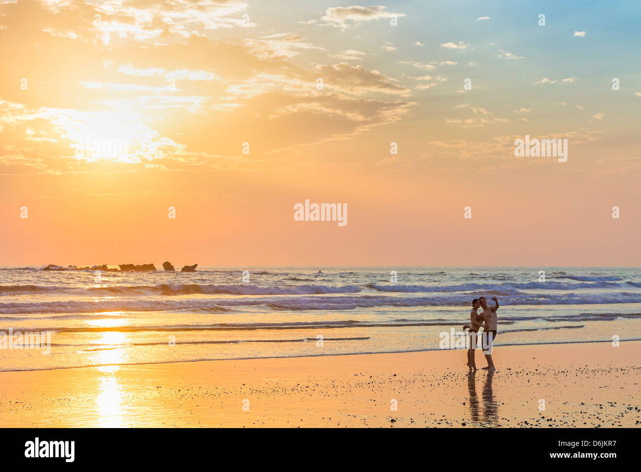 Couple photographing themselves au coucher du soleil, Playa Guiones Nosara Beach, surf, Péninsule de Nicoya, Province de Guanacaste, Costa Rica Banque D'Images