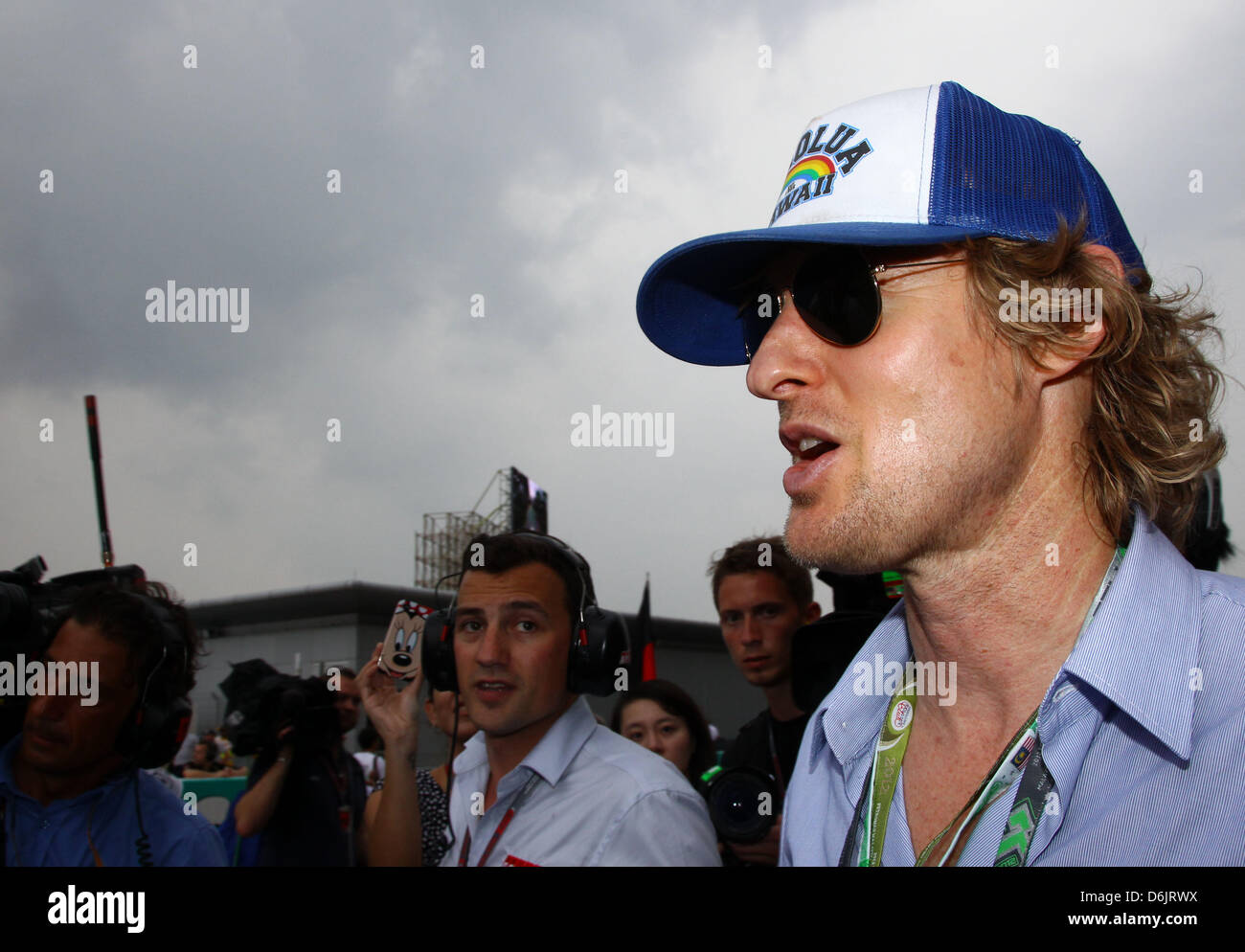 L'acteur américain Owen Wilson promenades à travers la grille de départ avant de commencer le Grand Prix de Formule 1 de la Malaisie à l'extérieur du circuit Sepang, Kuala Lumpur, Malaisie, 25 mars 2012. Photo : Jens Buettner dpa Banque D'Images