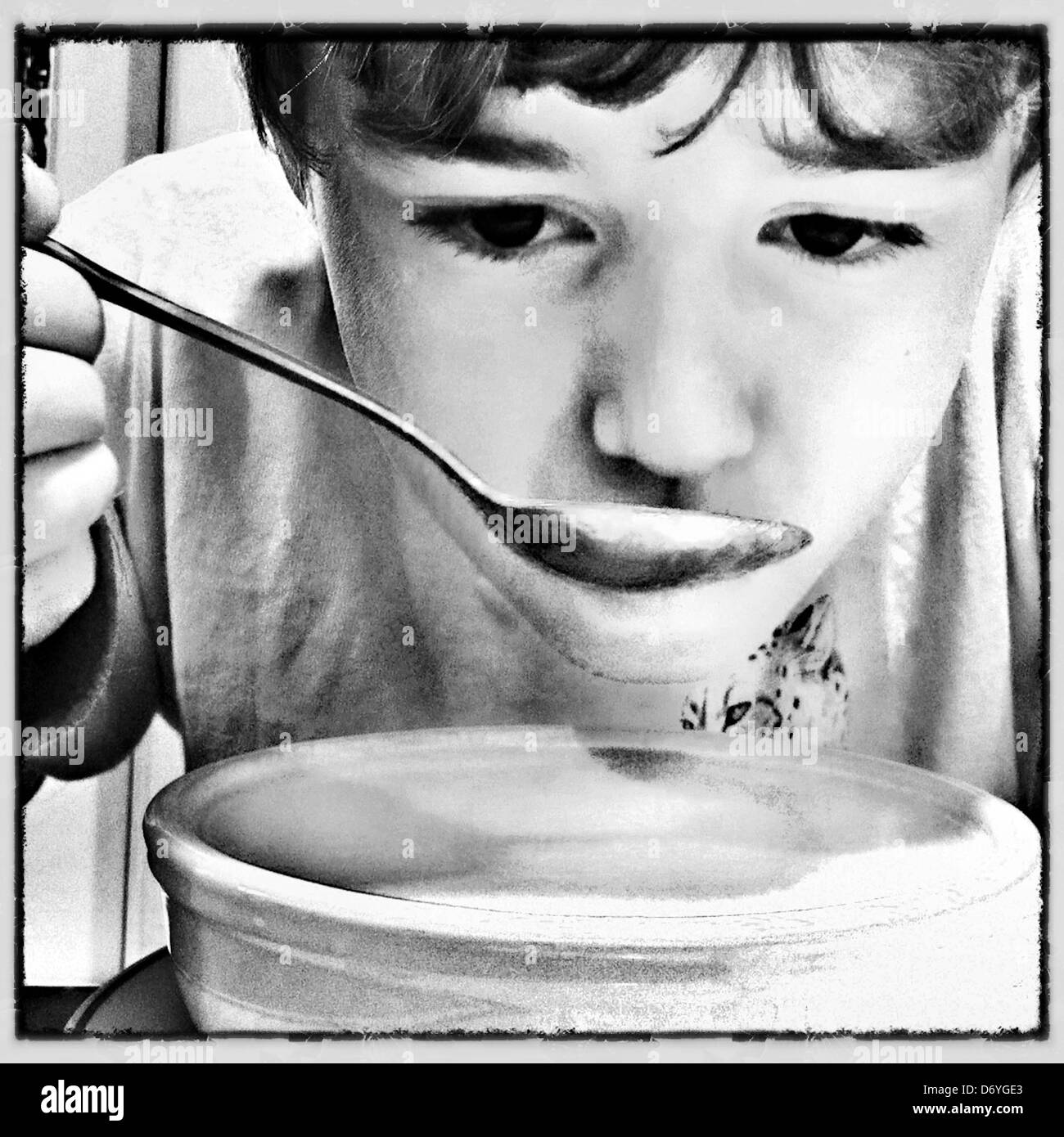 Caucasian boy eating soup Banque D'Images