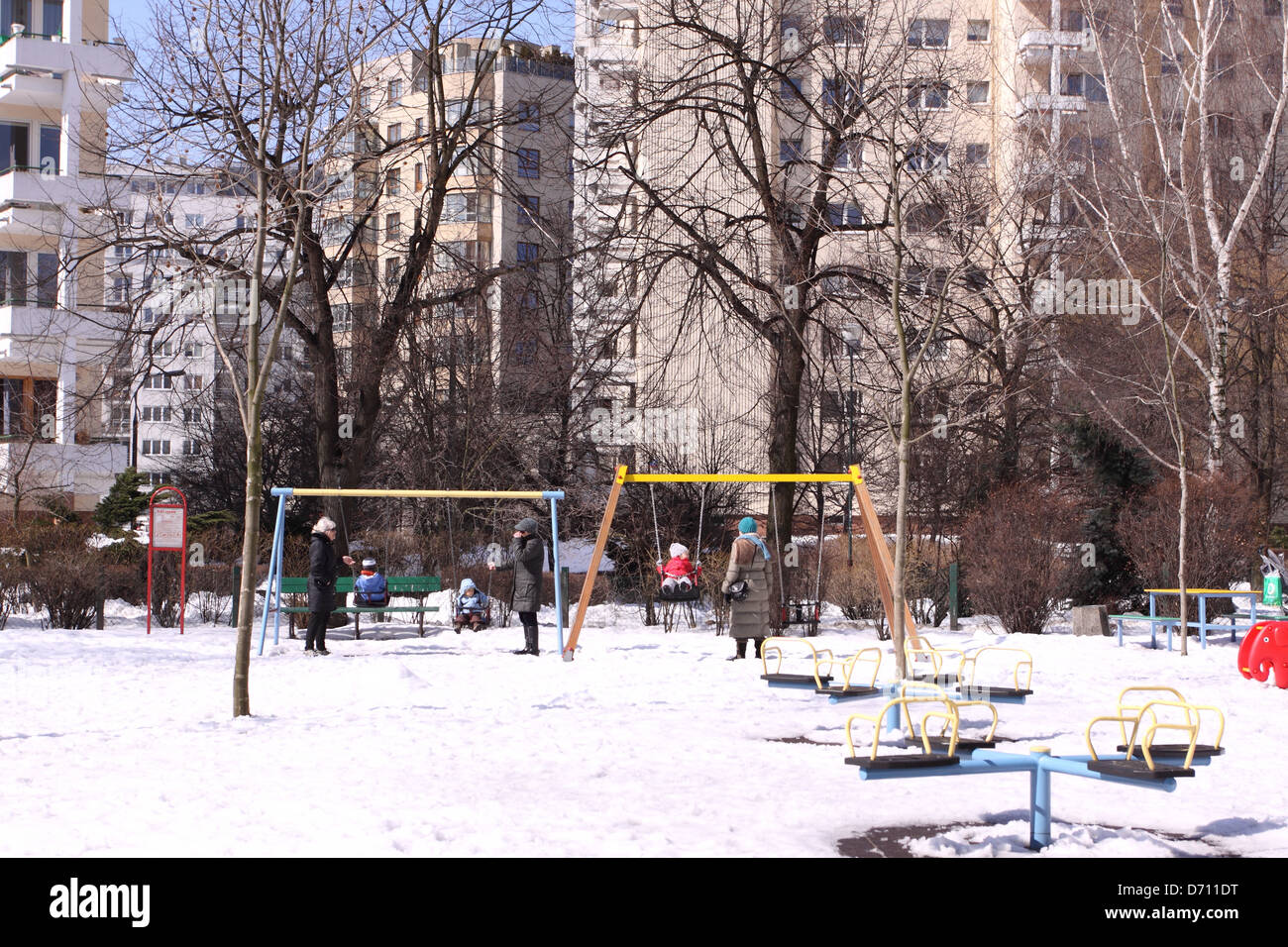 Varsovie Pologne enfants jouant dans une aire à l'extérieur des immeubles dans la neige de l'hiver dans la zone de la ville Stawki Banque D'Images