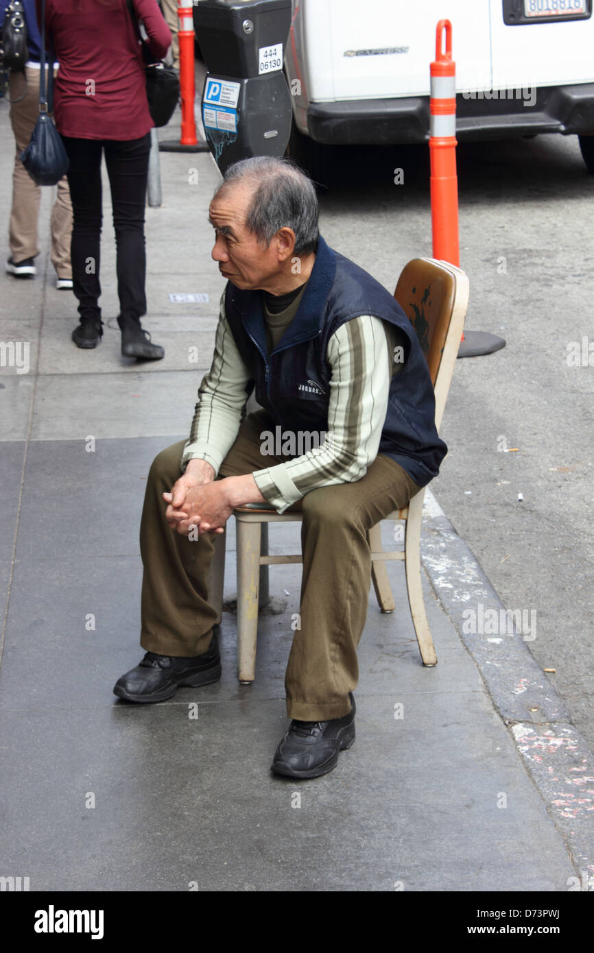 Un vieil homme chinois assis sur une chaise dans le Chinatown de San Francisco .qui est l'un des quartiers chinois les plus importants en Amérique du Nord, san francisco. Banque D'Images