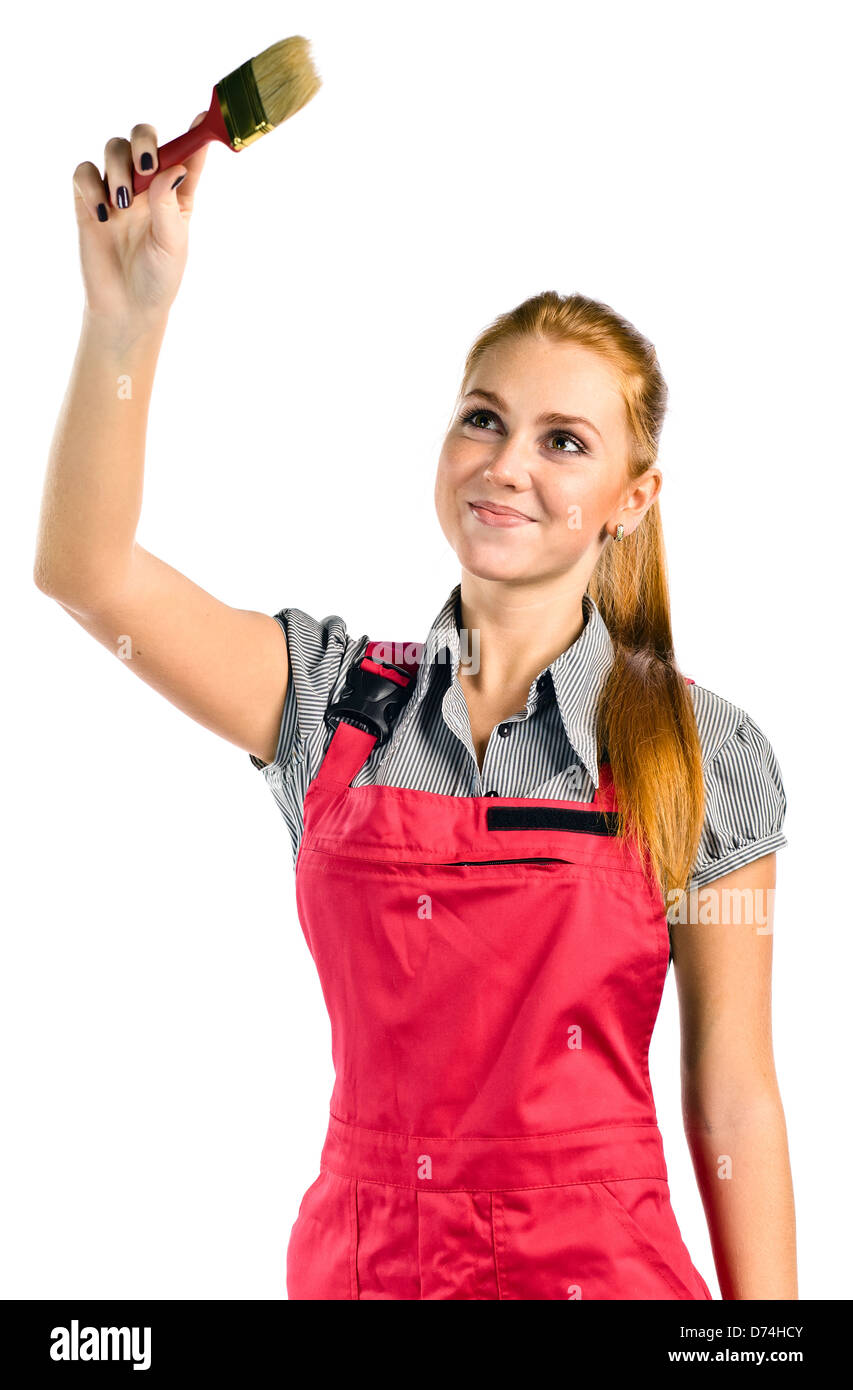 Jeune femme en salopette rouge avec pinceau , isolated on white Banque D'Images