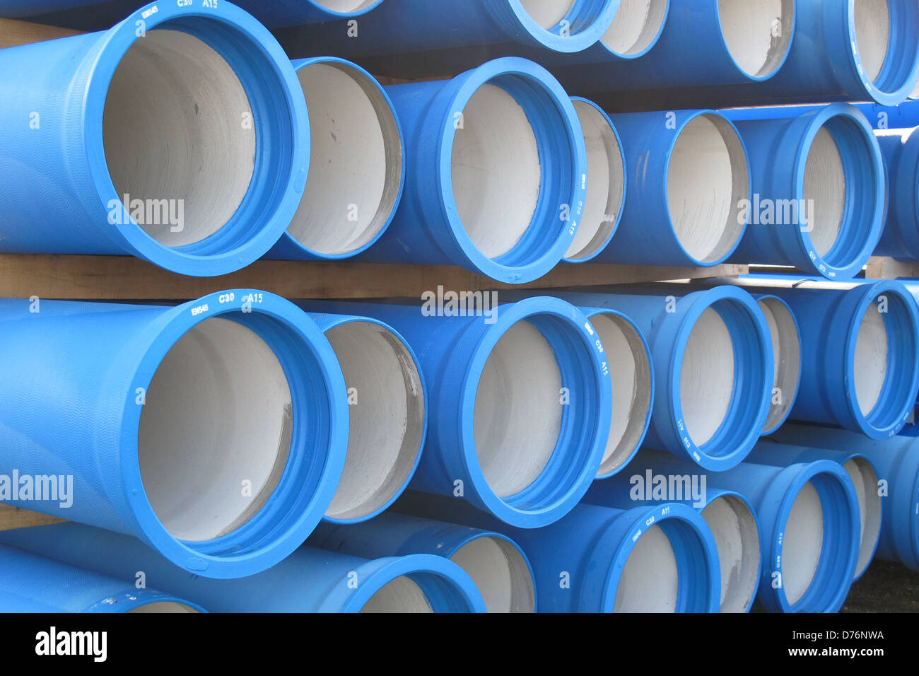 Des piles de béton tuyaux bleu pour transporter l'eau et d'assainissement Banque D'Images