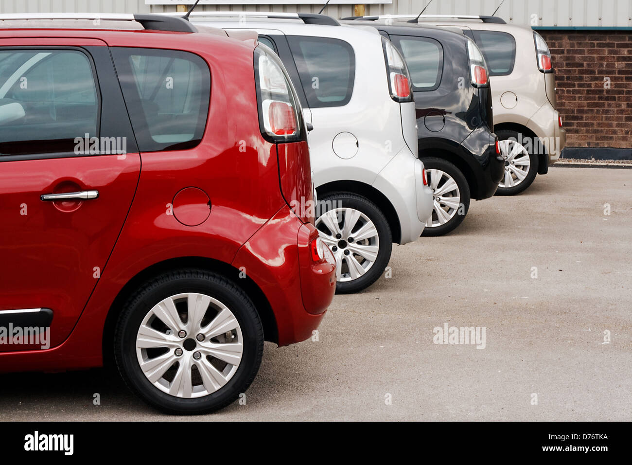Rangée de nouvelles voitures pour la vente au détail dans une cour de concessionnaires montrant même modèle dans différents choix de couleurs Banque D'Images