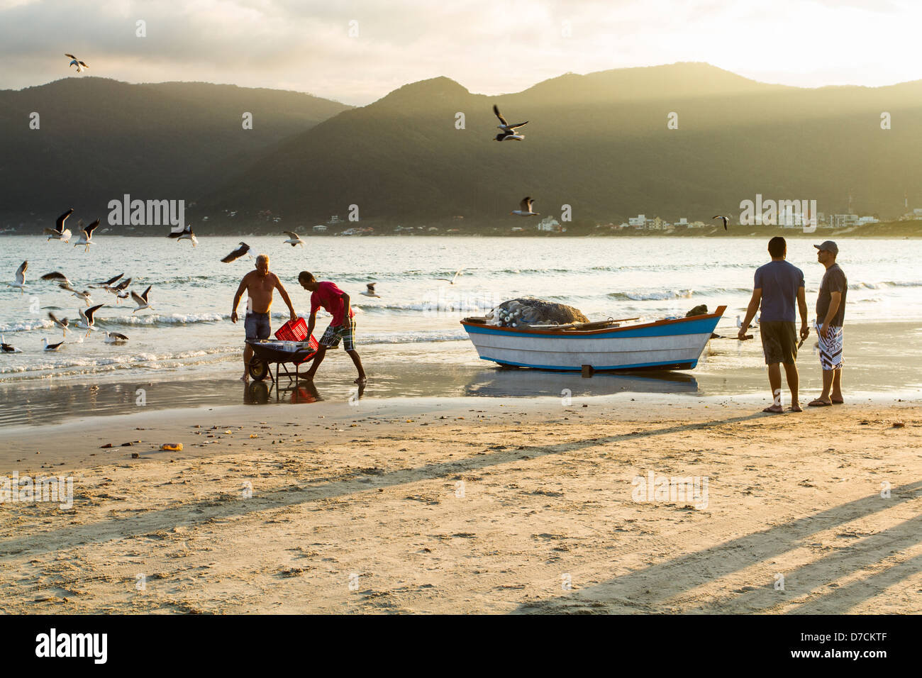 Bateau de pêche et pêcheurs sur le sable à Pantano do Sul Beach. Banque D'Images