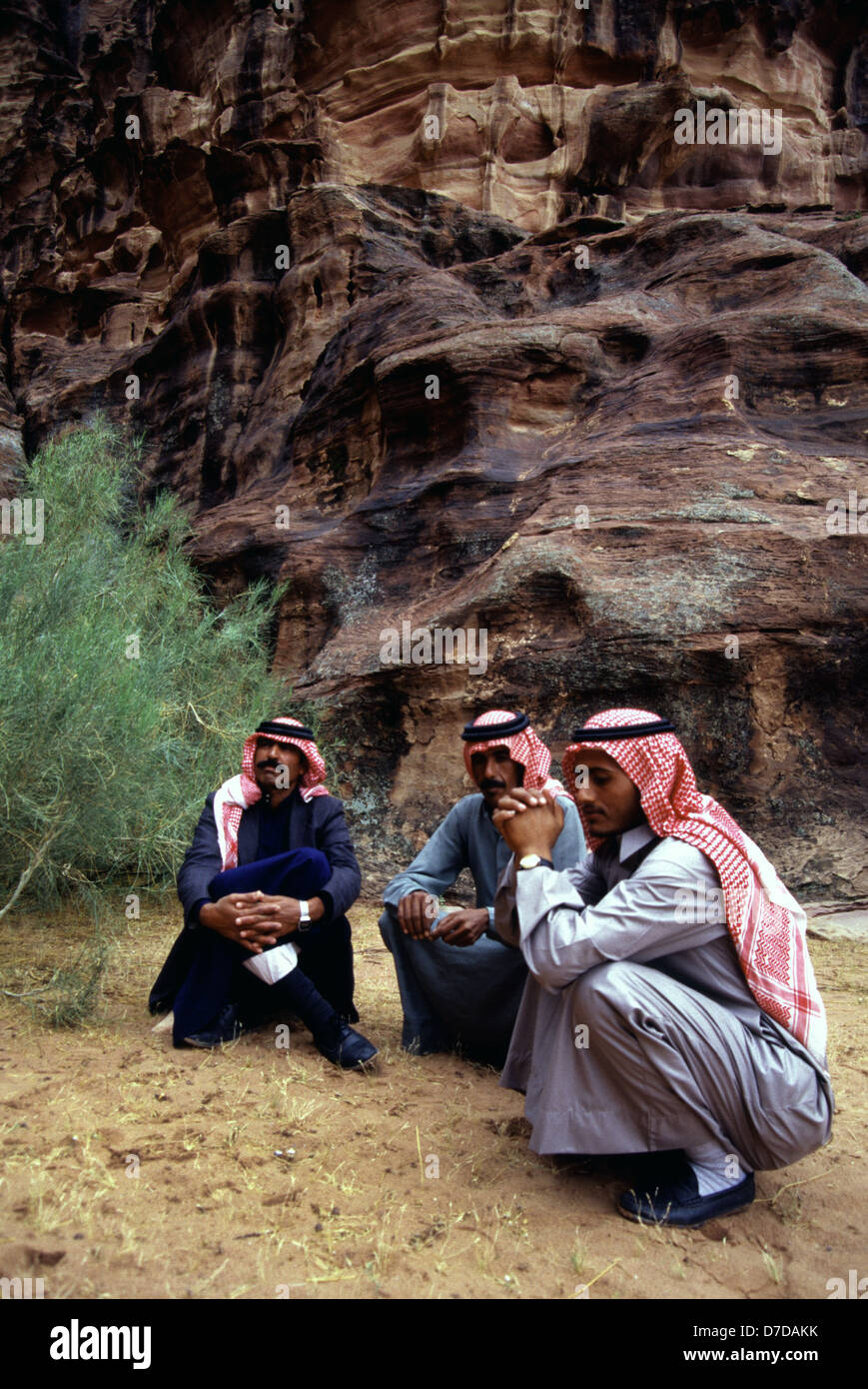 Bédouins portant un keffieh à carreaux blancs et rouges dans un ravin en grès Canyon Khazali dans le désert de Wadi Rum, également connu sous le nom de la vallée de la Lune, taillés dans la roche de granit et grès du sud de la Jordanie. Banque D'Images