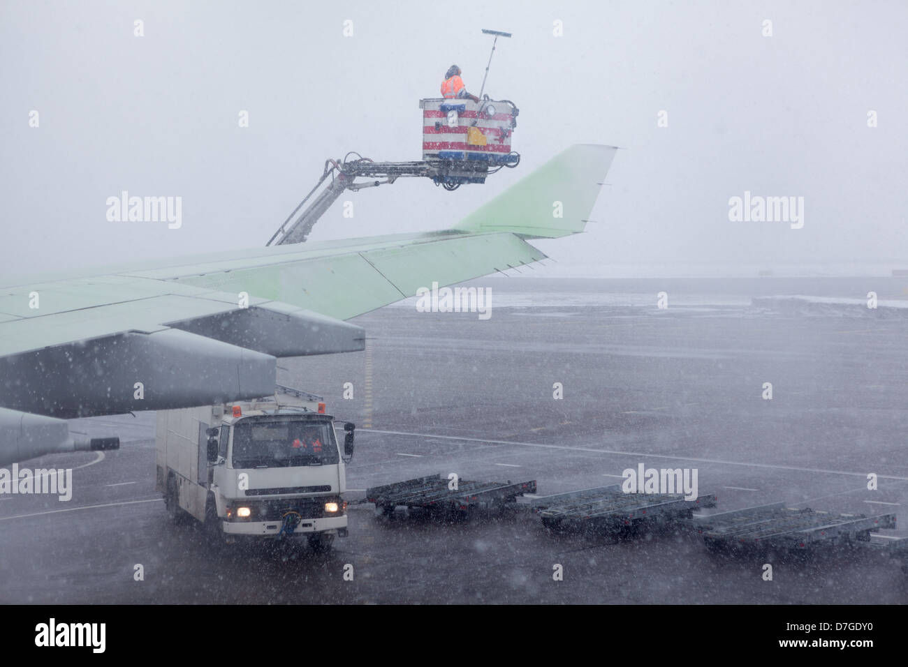 Traitement des fluides de dégivrage des avions ailes pendant une forte tempête de neige. Banque D'Images