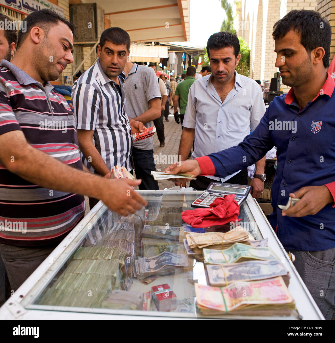 Les hommes d'échanger de l'argent et l'achat en monnaie étrangère à un service de change sur un marché à Erbil, Irak. Banque D'Images