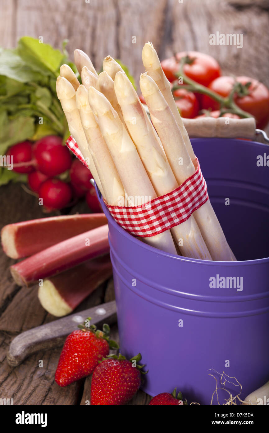 Dans un seau en métal est une bande d'asperges fraîches dans l'arrière-plan est un autre légume Banque D'Images