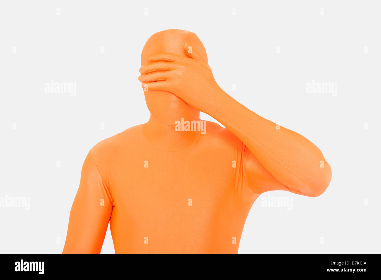 Homme mûr en orange zentai avec mains couvrant les yeux Banque D'Images
