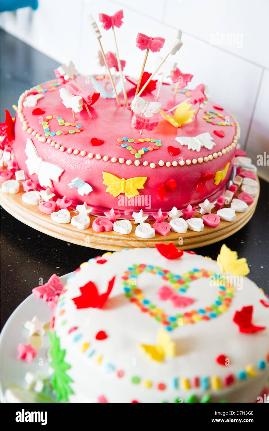 Décorées de couleurs blanches et roses massepain gâteaux pour un anniversaire sur commode cuisine Banque D'Images