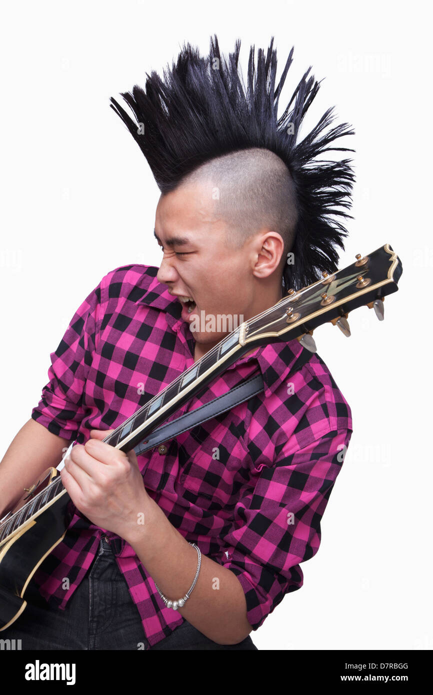 Jeune homme avec punk qui joue de la guitare Mohawk Banque D'Images